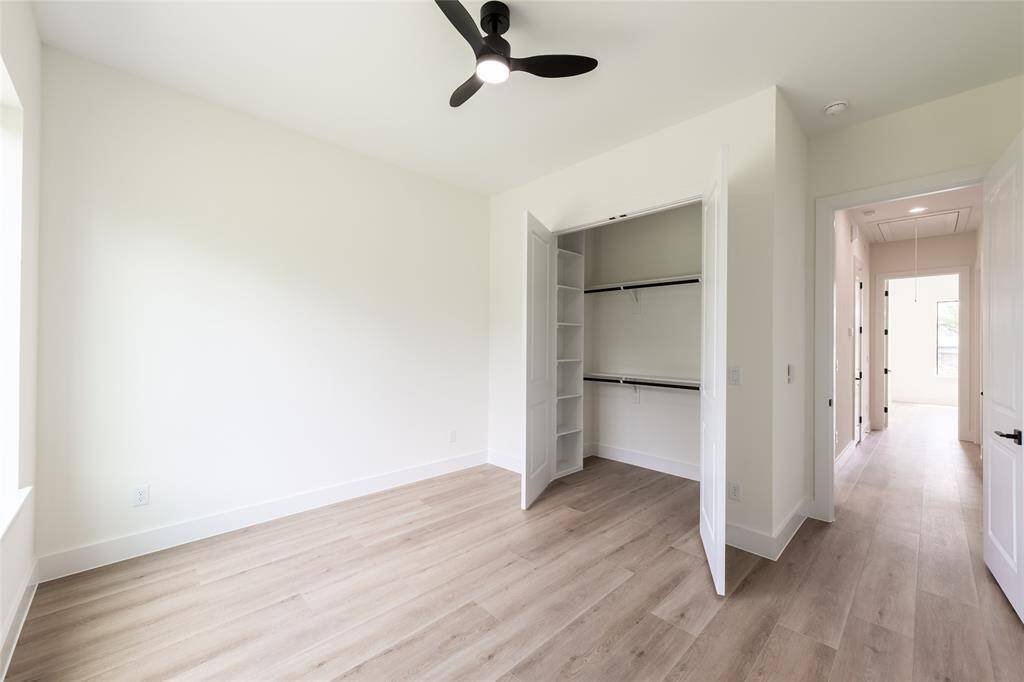 One of the generously sized secondary bedrooms, offering plenty of natural light and versatile space for relaxing or working.