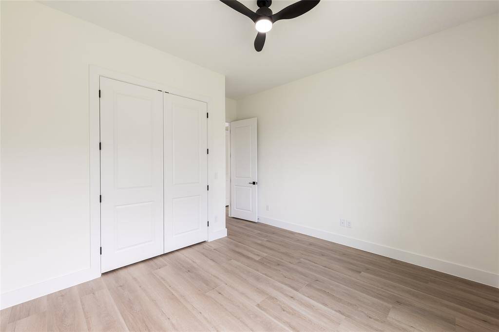 One of the generously sized secondary bedrooms, offering plenty of natural light and versatile space for relaxing or working.