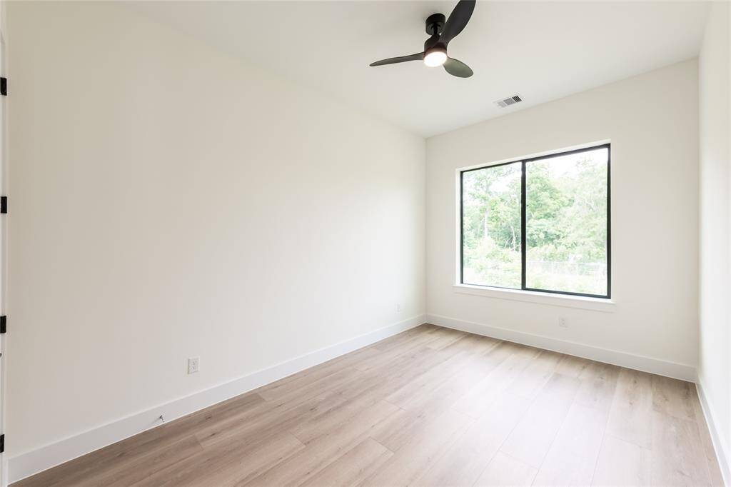 The other spacious secondary bedroom, perfect for guests, a home office, or a cozy retreat.