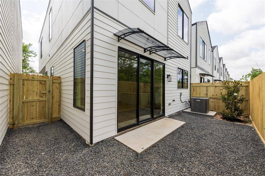 Low-maintenance backyard featuring a covered awning—ideal for outdoor relaxation and entertaining rain or shine.