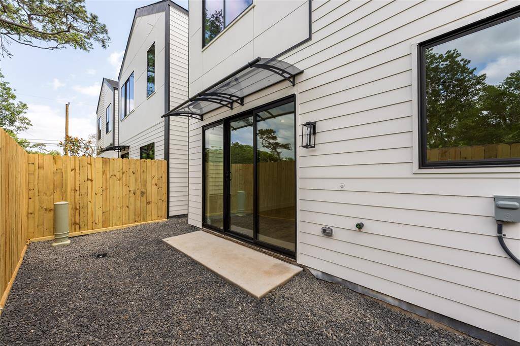 Low-maintenance backyard featuring a covered awning—ideal for outdoor relaxation and entertaining rain or shine.
