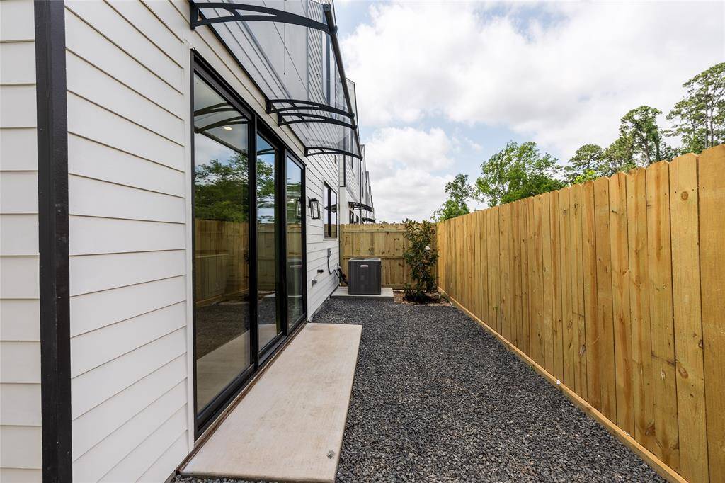 Low-maintenance backyard just off the living room, featuring a covered awning—perfect for easy outdoor living and entertaining.