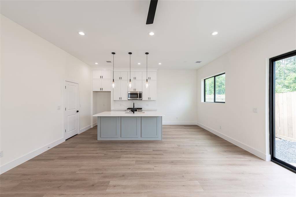 To the left, a large walk-in pantry offers ample storage—perfect for families—while to the right, a cozy breakfast area provides the ideal spot for casual dining.
