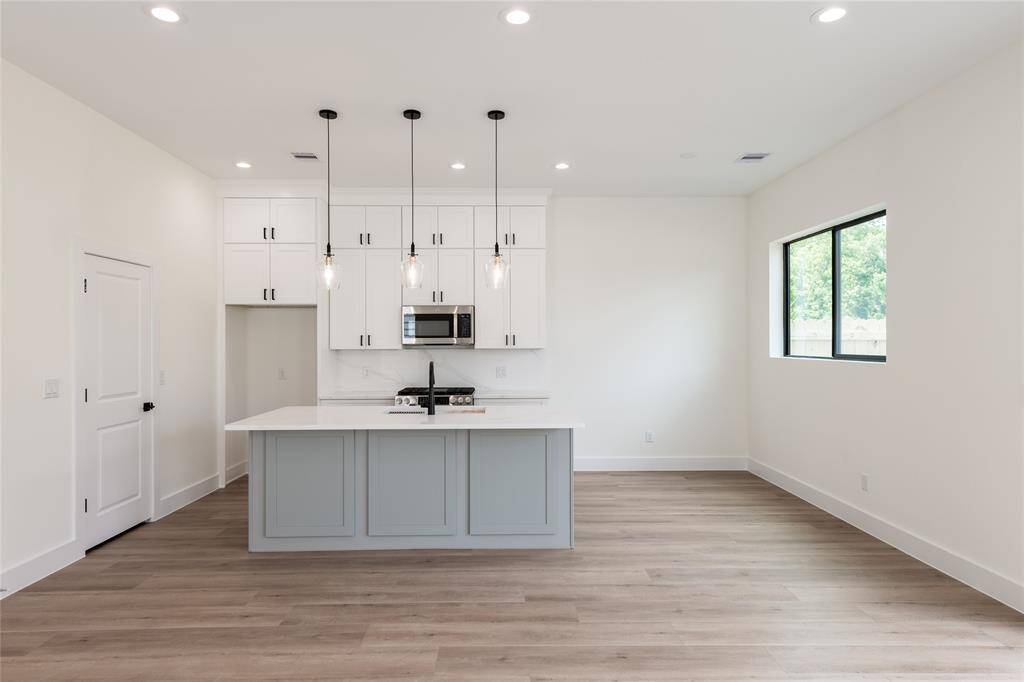 To the left, a large walk-in pantry offers ample storage—perfect for families—while to the right, a cozy breakfast area provides the ideal spot for casual dining.