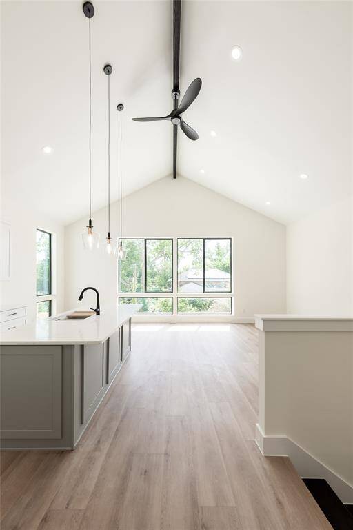 Absolutely stunning 14-foot cathedral ceilings with an exposed beam, creating a grand and airy atmosphere.