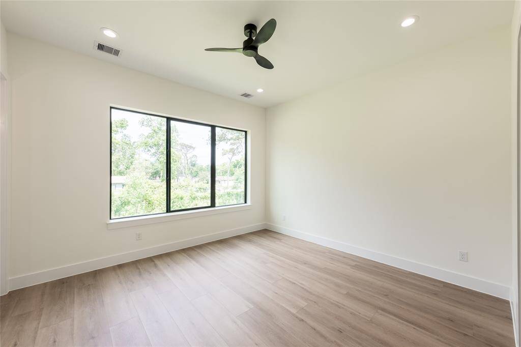 Bright and spacious primary bedroom filled with natural light, creating a warm and inviting retreat.