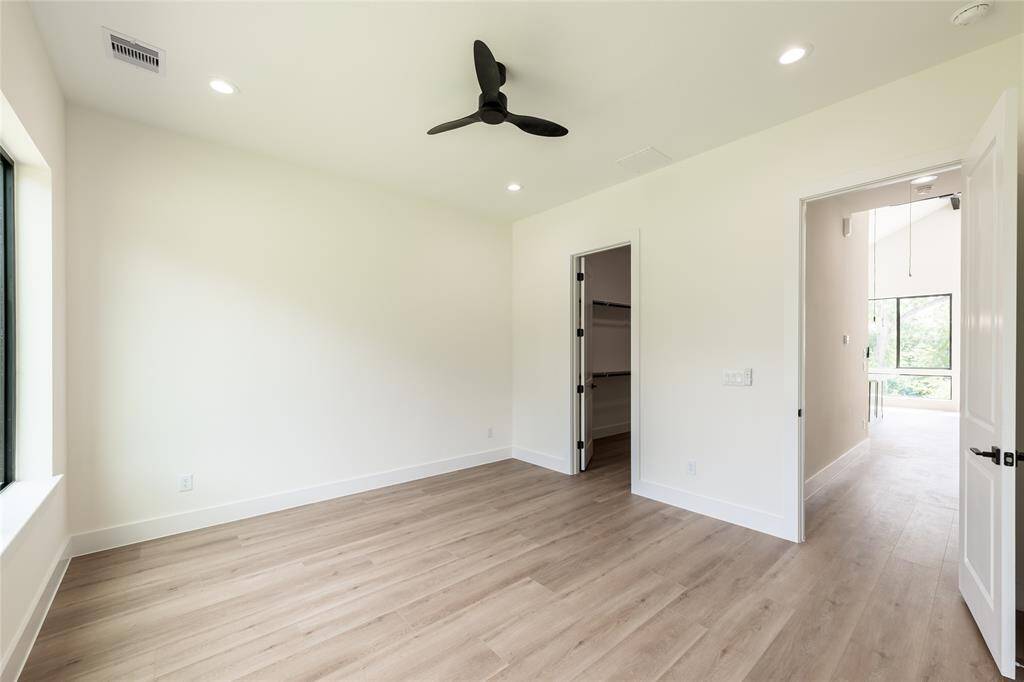 Alternate angle of the primary bedroom showcasing the entryway, offering a sense of flow and spaciousness throughout the suite.