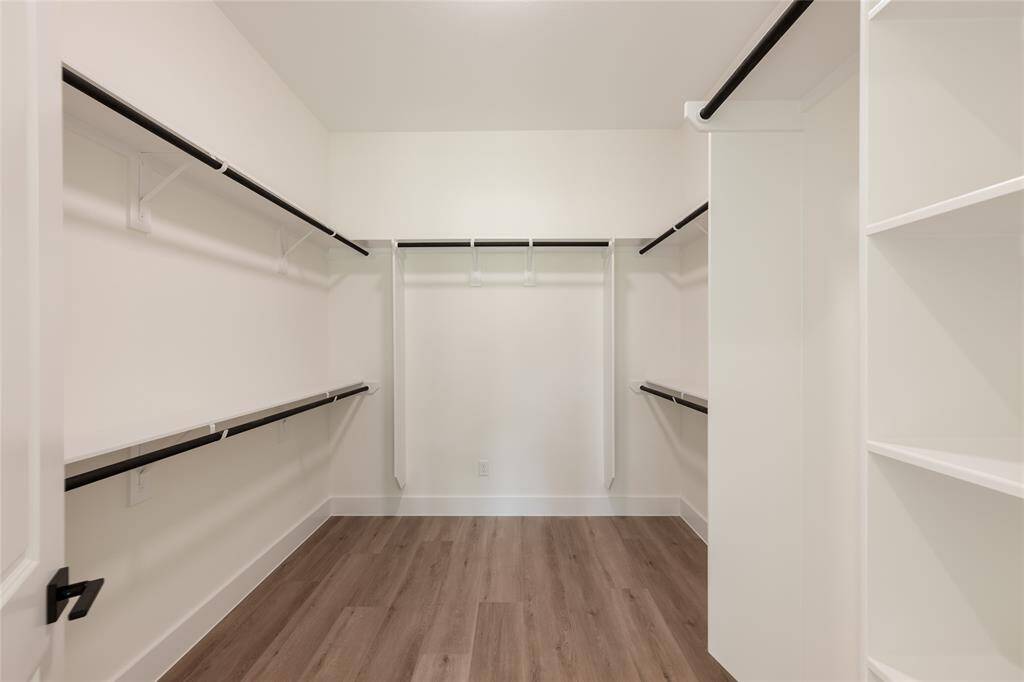 Expansive walk-in closet in the primary suite, providing abundant space for organized storage and wardrobe essentials.
