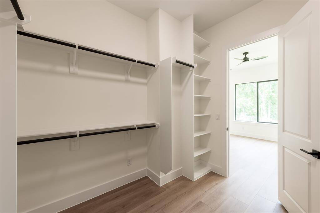 Expansive walk-in closet in the primary suite, providing abundant space for organized storage and wardrobe essentials.