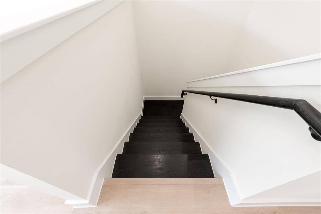 Let’s head down to explore the other two bedrooms, the full bath, and the backyard space—perfect for family living and relaxation.