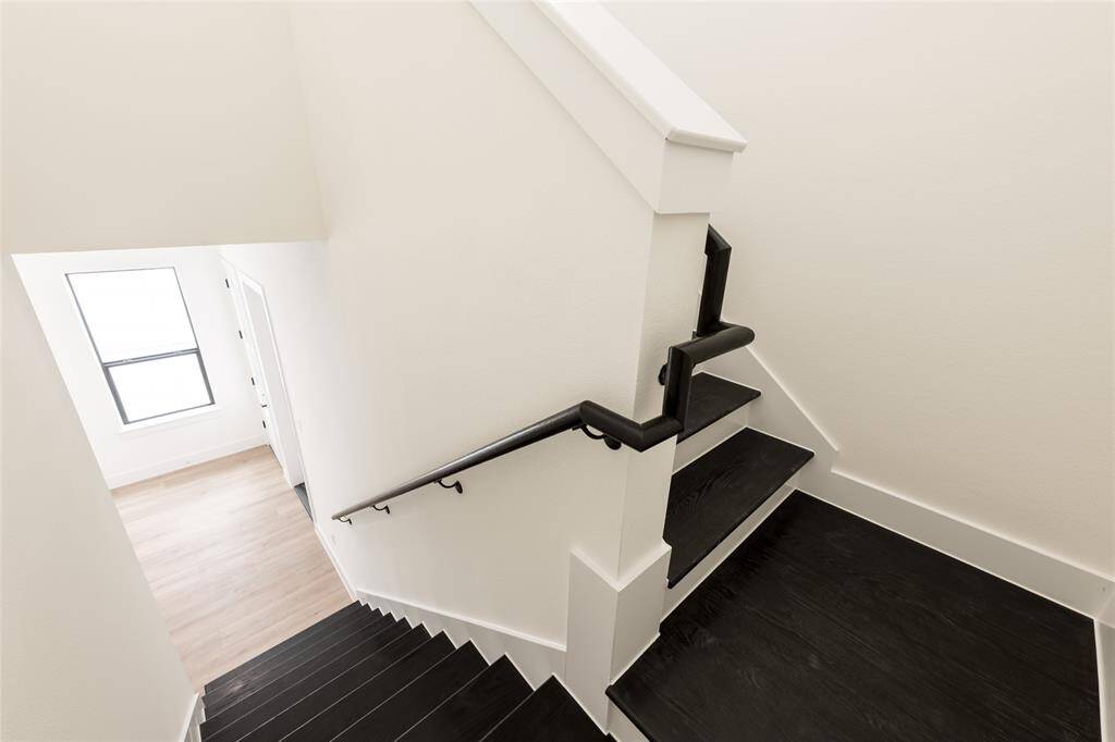 The stairs feature beautiful hardwood flooring, adding warmth and elegance as you move between levels