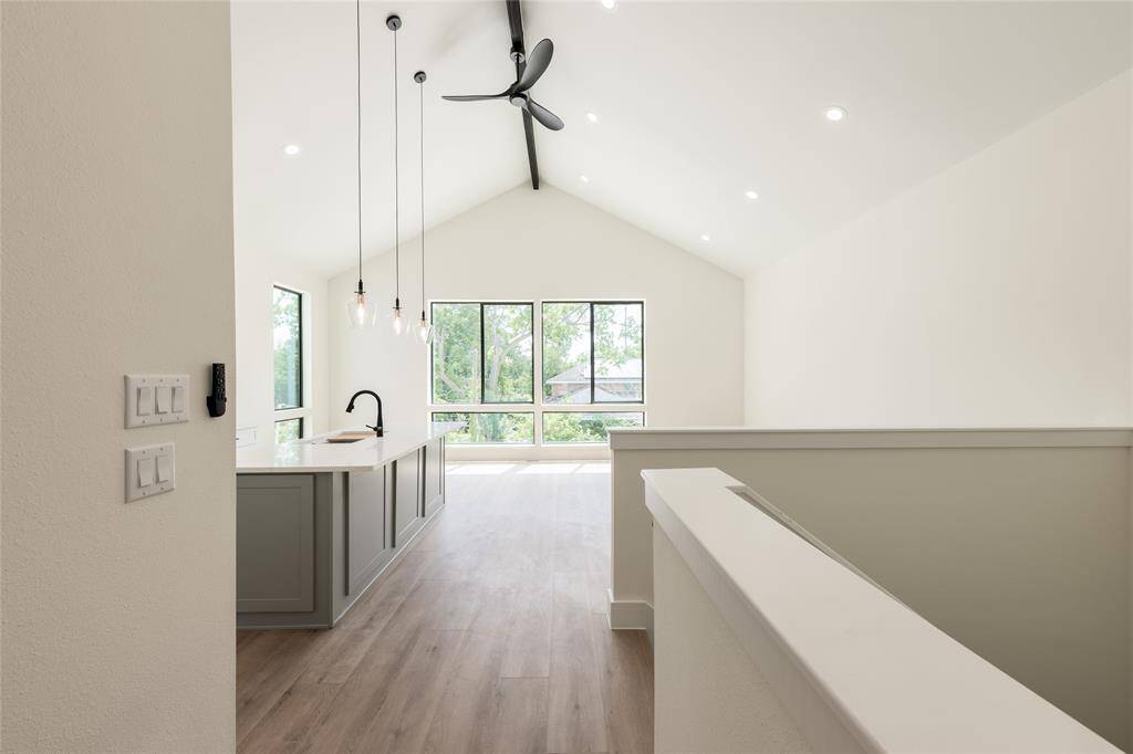 "Prepare to be amazed by soaring 14-foot cathedral ceilings with a striking exposed beam, flooding the living, kitchen, and dining areas with an expansive, breathtaking sense of space and elegance.