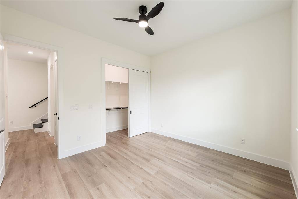 One of the spacious secondary bedrooms, offering ample natural light and versatile space for sleeping, studying, or relaxing.