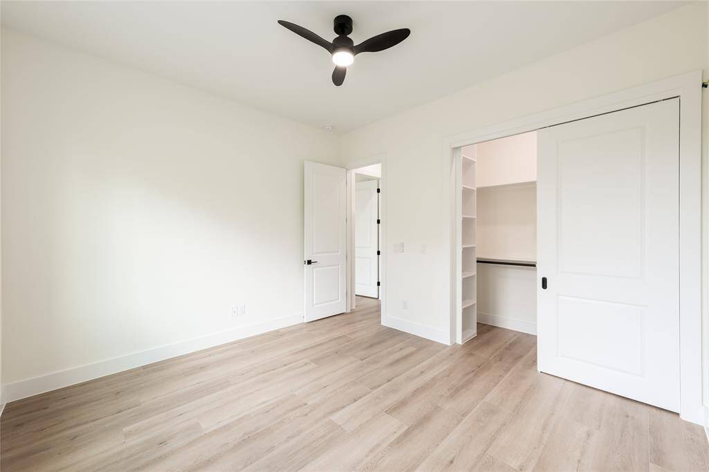 One of the spacious secondary bedrooms, offering ample natural light and versatile space for sleeping, studying, or relaxing.