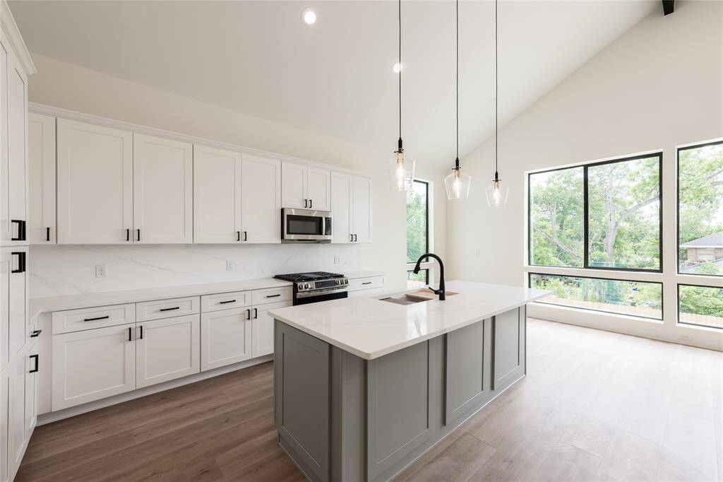 A chef’s dream kitchen featuring a spacious island with a built-in sink, ample cabinetry for storage, and elegant under-cabinet lighting that enhances both functionality and ambiance.
