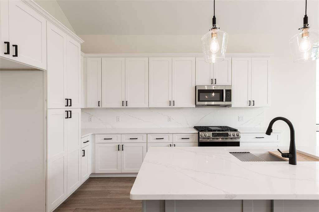 A chef’s dream kitchen featuring a spacious island with a built-in sink, ample cabinetry for storage, and elegant under-cabinet lighting that enhances both functionality and ambiance.