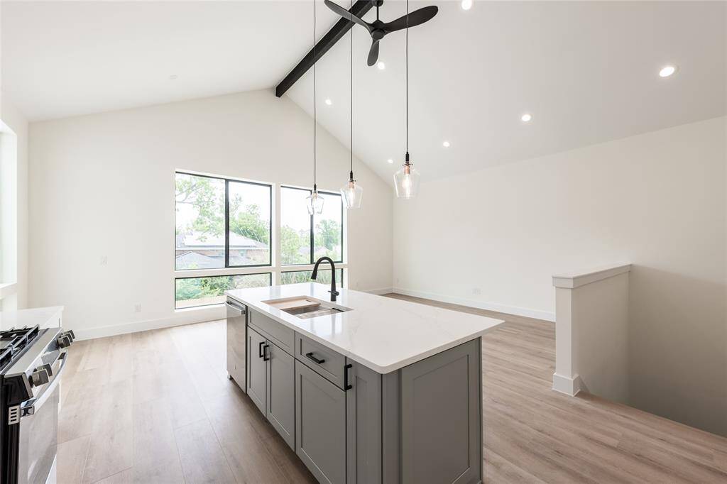 This view captures the chef’s dream kitchen flowing seamlessly into the spacious living room, creating an open and inviting space for family and guests.