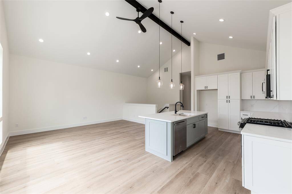 This view captures the chef’s dream kitchen flowing seamlessly into the spacious living room, creating an open and inviting space for family and guests.
