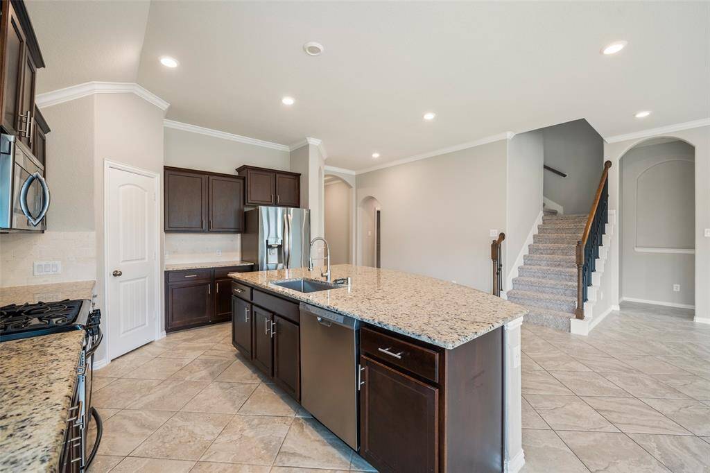 Stainless steel appliances and neutral flooring will go with any decor.