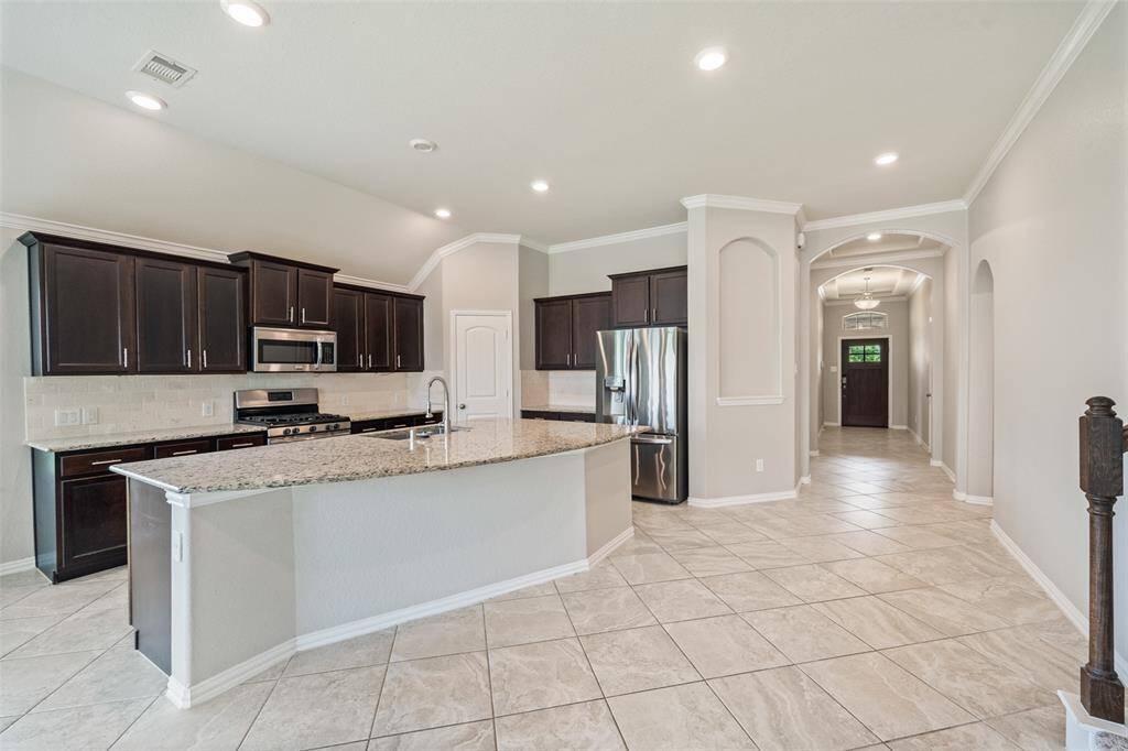 Another view of the kitchen and entry