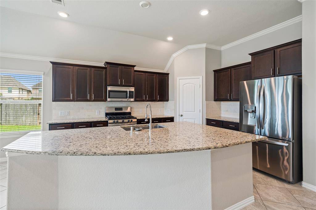 Look at the size of this granite island with sink! Allows for extra sitting if needed .