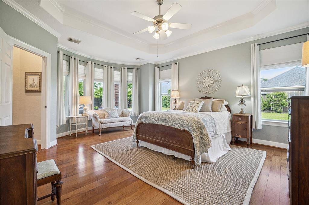 Relax in refined style in the spacious primary retreat with tray ceiling, decorative molding and impressive ensuite bath.