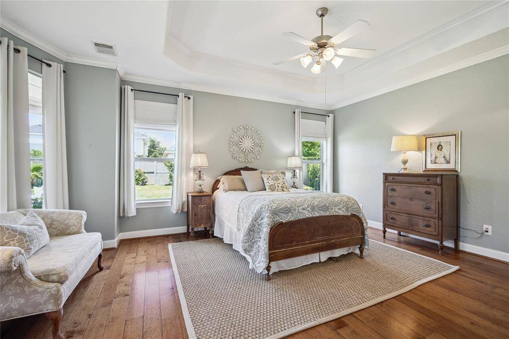 Back into the primary bedroom, the wall of windows offers a picture perfect view of the amazing backyard pool & spa!