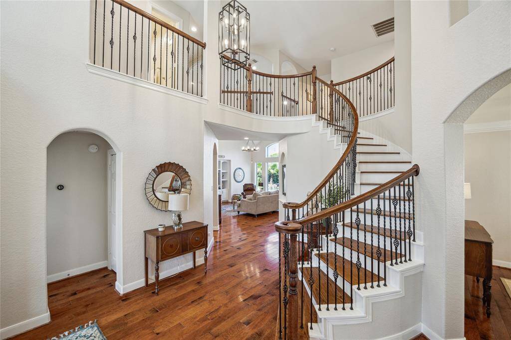 Heading towards the front of the house, there is another bedroom and bath on the first floor through the archway to the left.