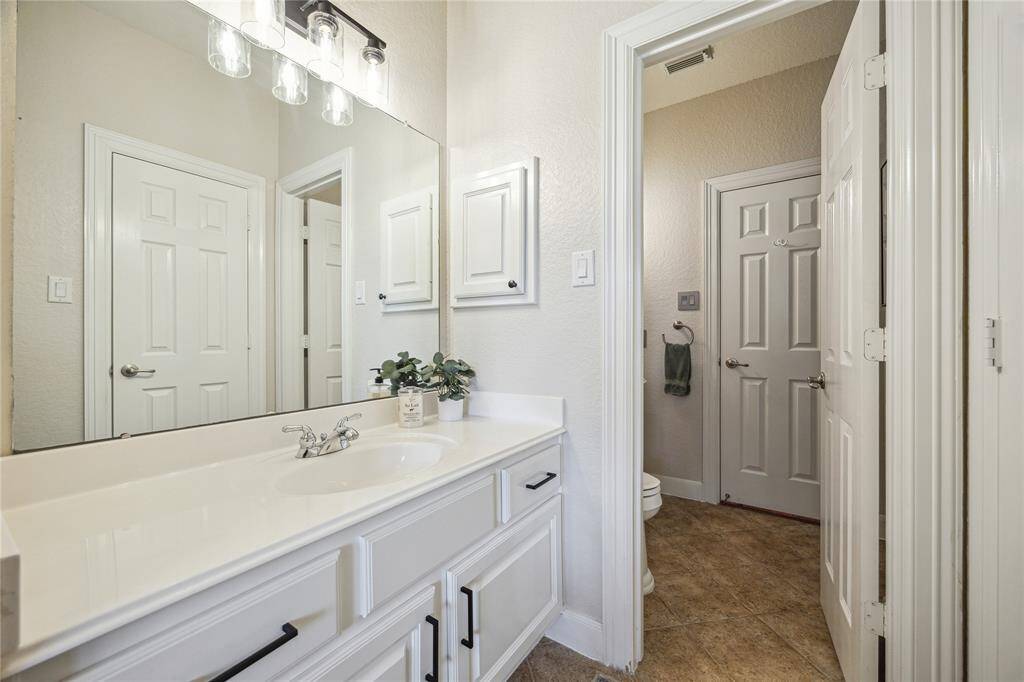A vanity area connects the bedroom to bathroom. The bathroom can also be access from the hallway, making it convenient for guests.