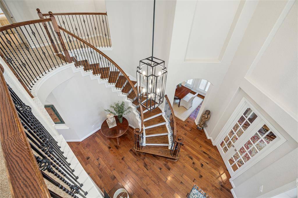 Heading upstairs, the dramatic curved staircase leads to 3 additional bedrooms, game room, media room and study nook.