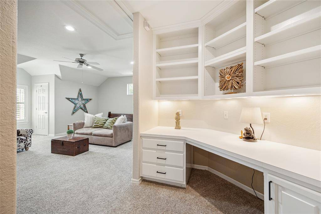 Just down the hall is a study nook with built-ins, a perfect place for kids to do homework or set up your home computer.