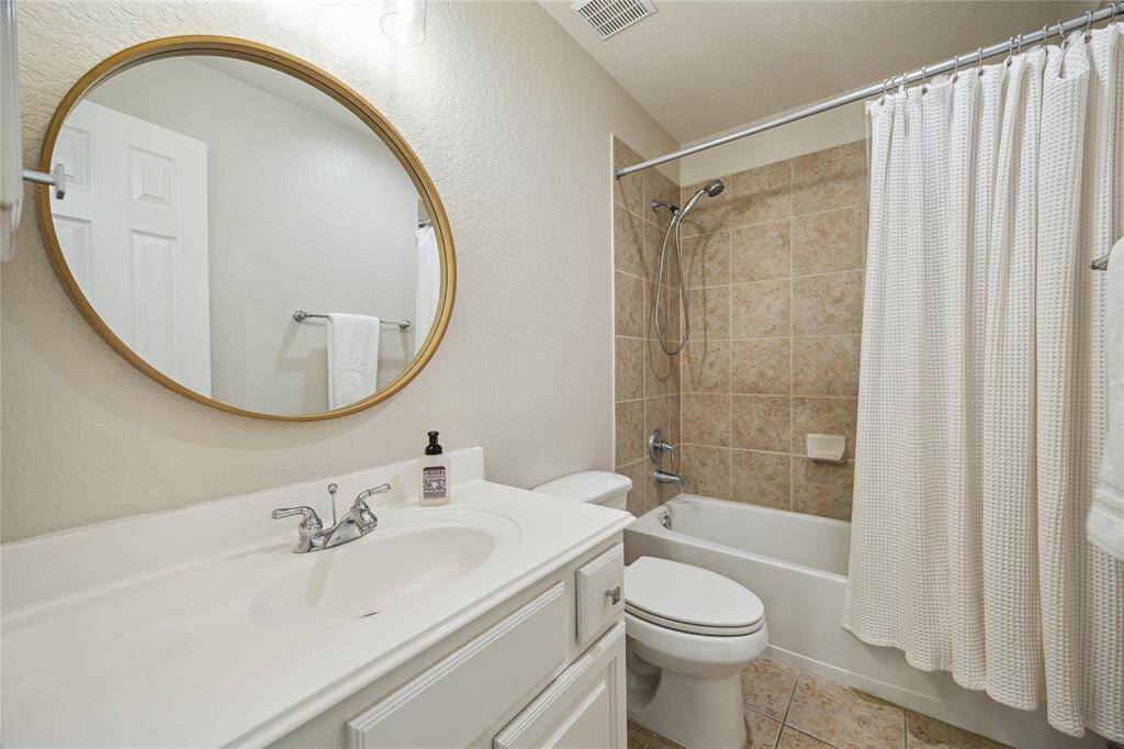 This bathroom with tub/shower serves the first bedroom and the game room/media room.