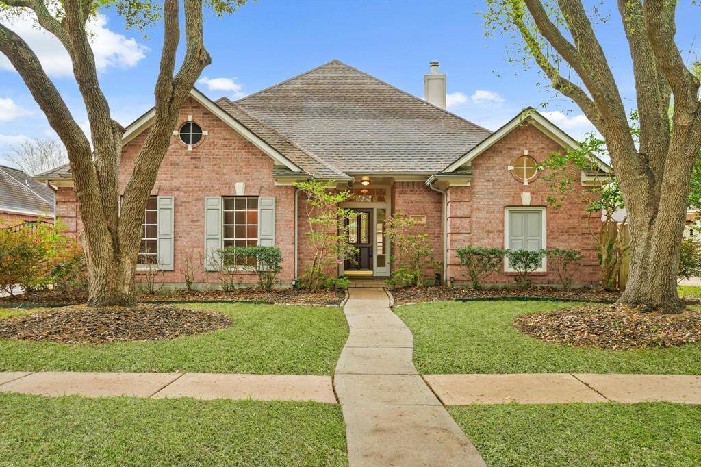 The meticulously maintained lush front lawn adds vibrant curb appeal, offering an inviting first impression.
