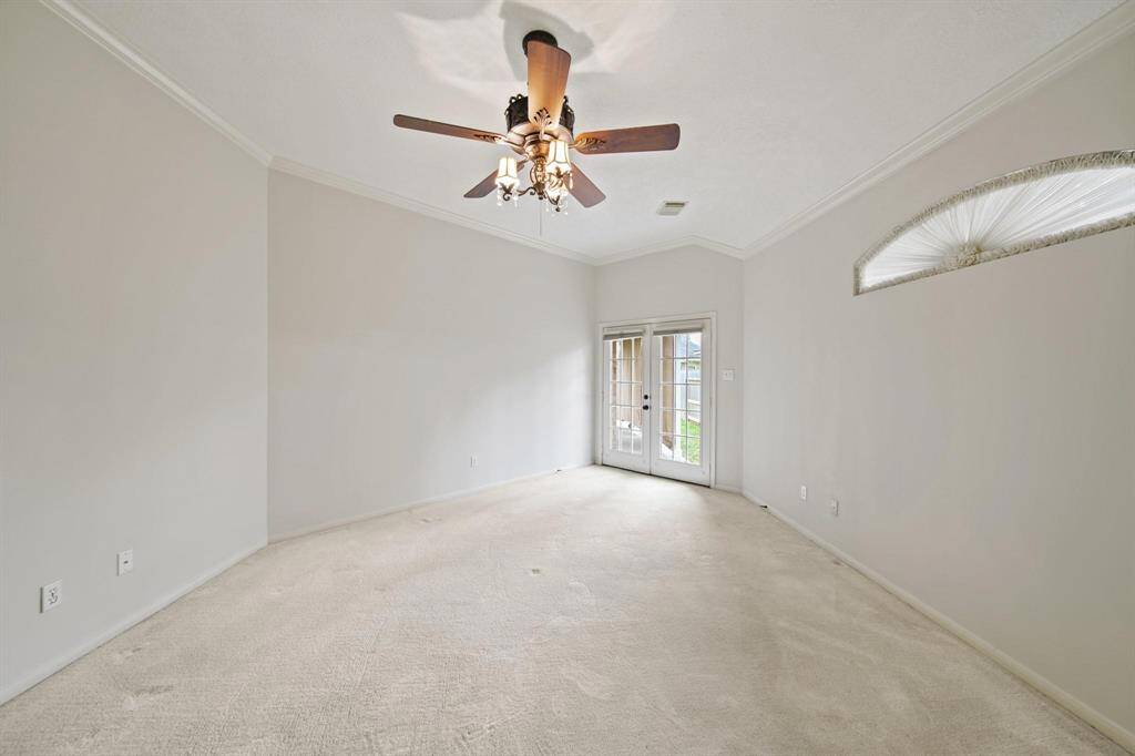 The primary bedroom features a large French door that opens directly to the backyard, allowing for seamless indoor-outdoor living. Wake up to natural light and enjoy easy access to outdoor relaxation.