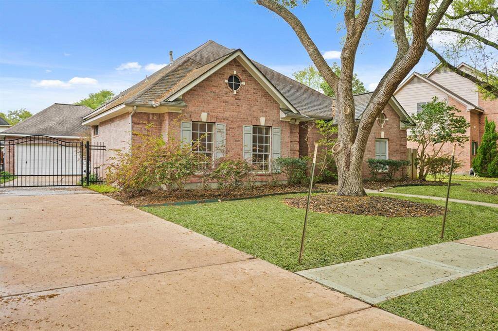 Tucked discreetly on the side is the 2-car attached garage with an extensive driveway.