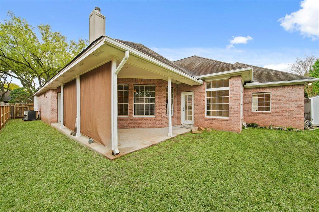 The home's classic brick enhances the aesthetic of the backyard.