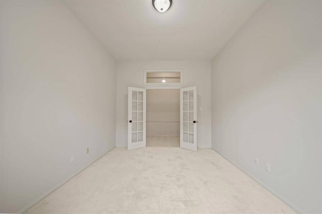 This private study boasts stylish French doors that open to soft carpet flooring.