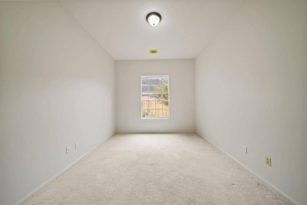 Another angle of the private room featuring high ceilings and a large window that flood the space with natural light.
