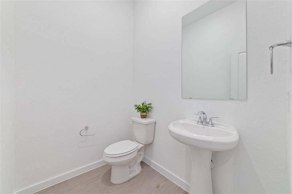 Powder room on the main floor near the utility room and entrance from the garage