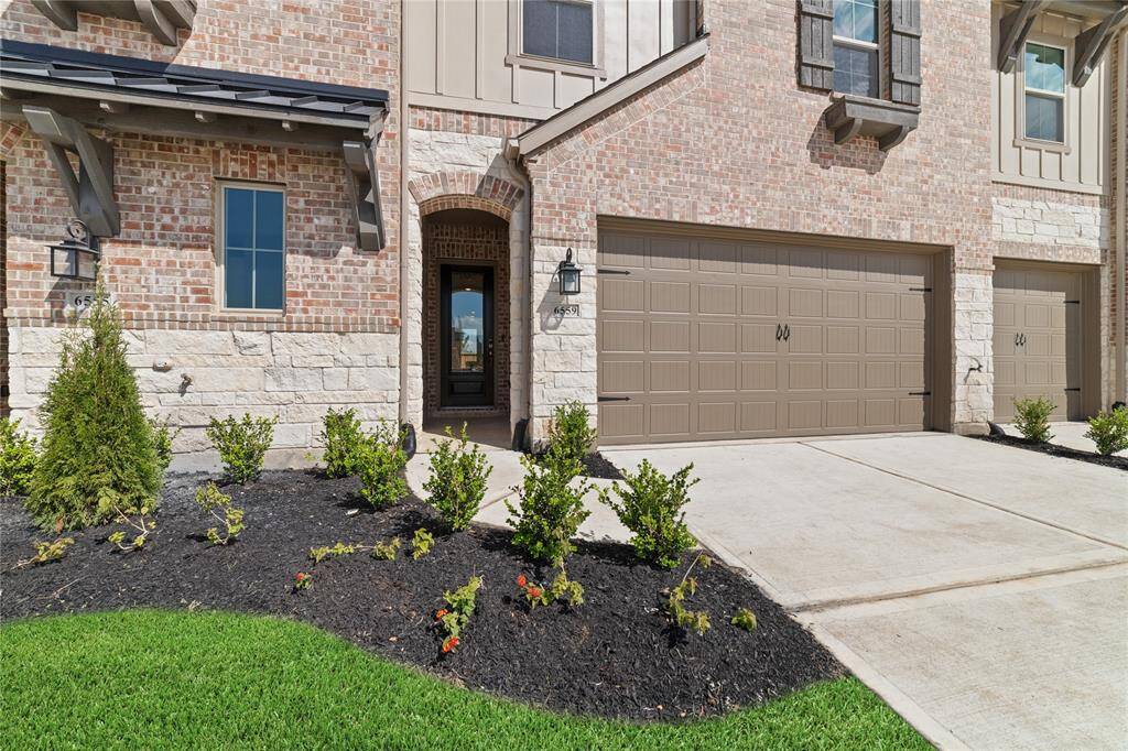 Landscaped front yard with double-wide, 2-car driveway