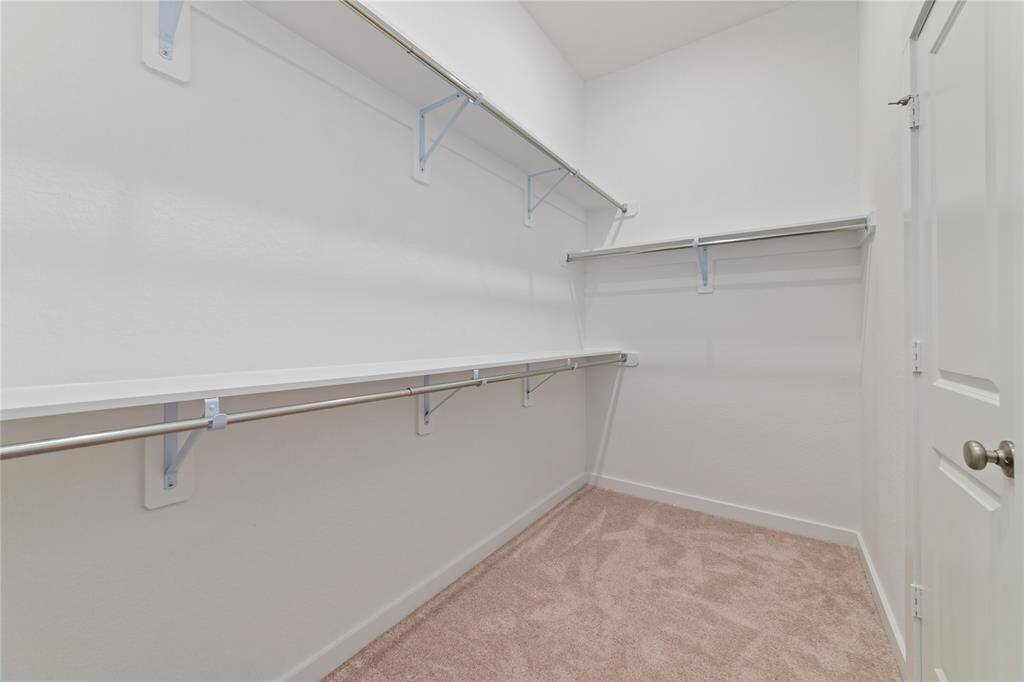 Large full-entry closet with shelving and built in rods