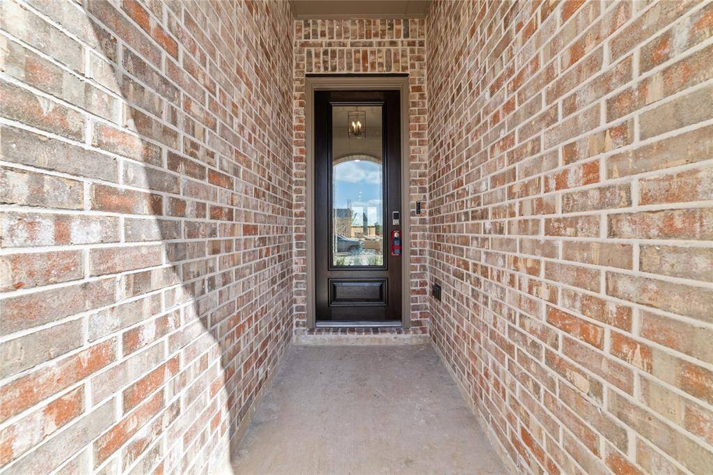 Shaded entrance with secured keypad entry to the 2,173 sq. ft townhome