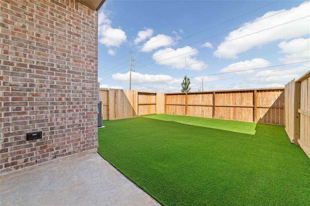 Backyard space has easy-to-maintain AstroTurf instead of sod, and no back neighbors