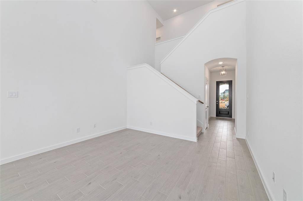 Opposite view of the main floor with 2-story high ceilings and split-level staircase