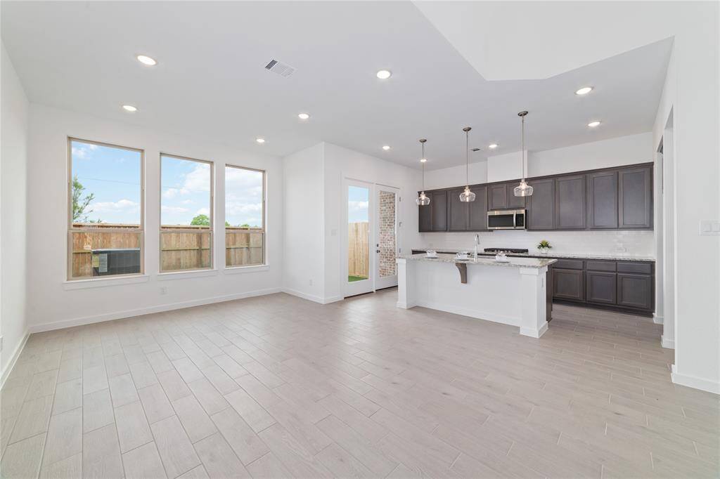 Gorgeous cabinetry, pendant lighting, and recessed lighting in the kitchen