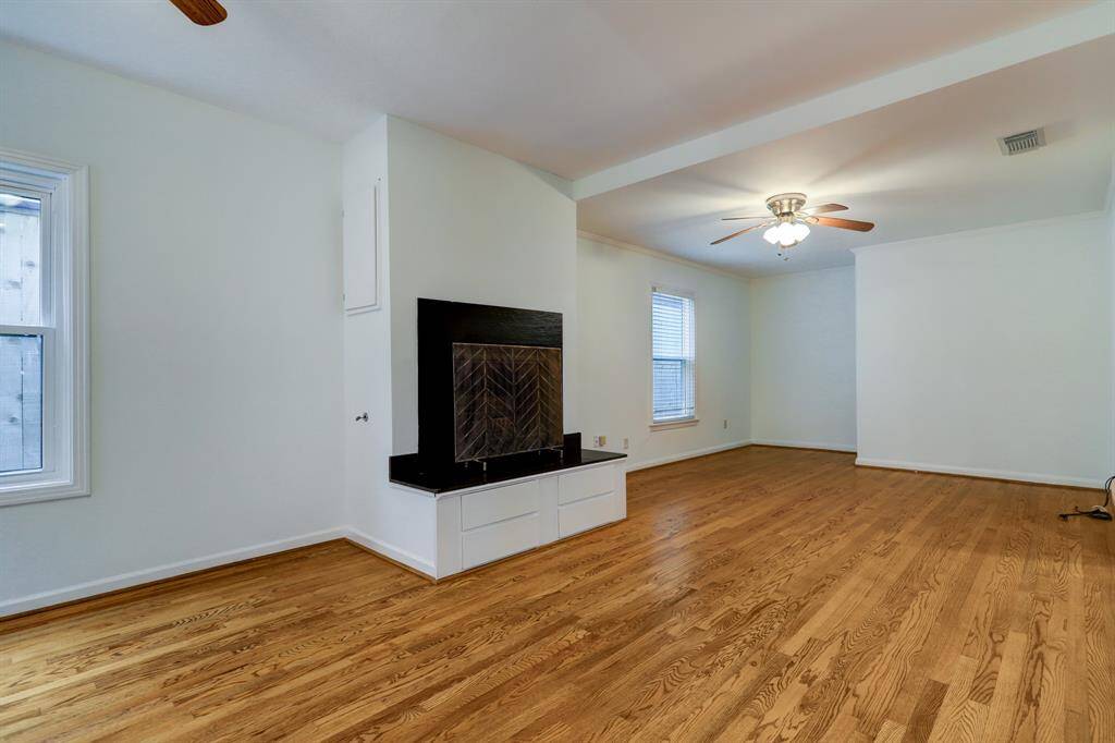 Den off of Kitchen with view of gas log fireplace.