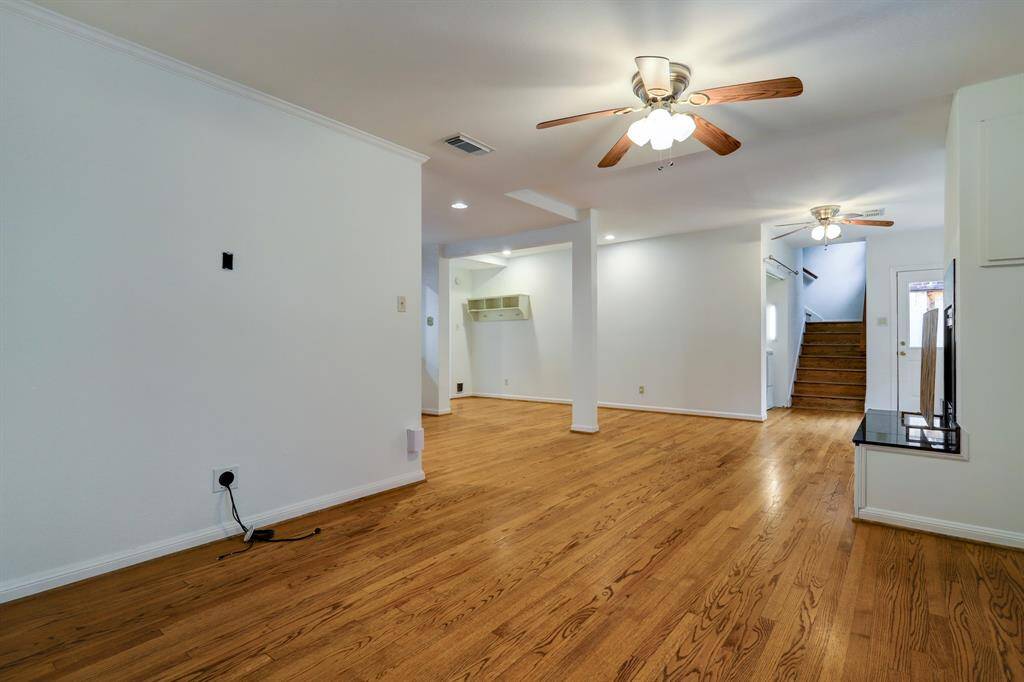 View of Den, looking towards back door and stairway leading to the 2 secondary bedrooms with en-suite bathrooms.