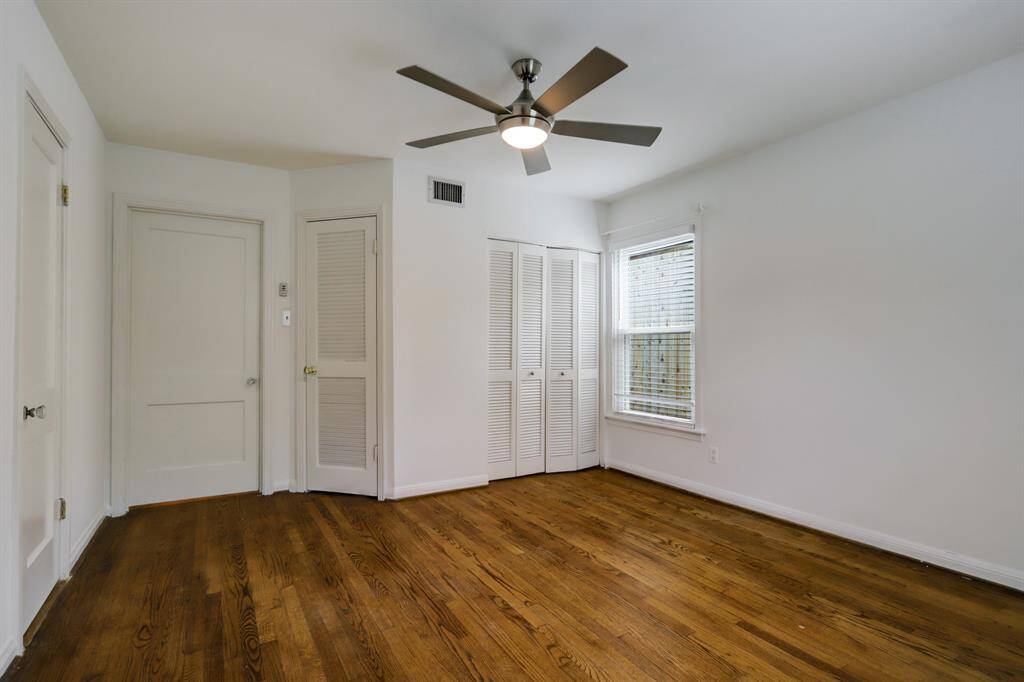 Another view of downstairs bedroom with closet doors in the distance.
