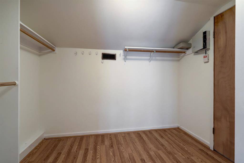The interior of one of the two large walk-in closets in the primary suite.