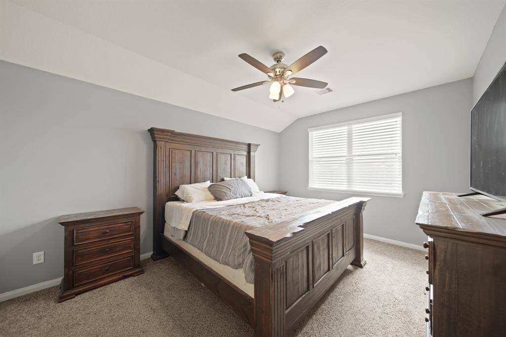 Escape to the Primary Suite with the Vaulted Ceiling and Backyard Views.